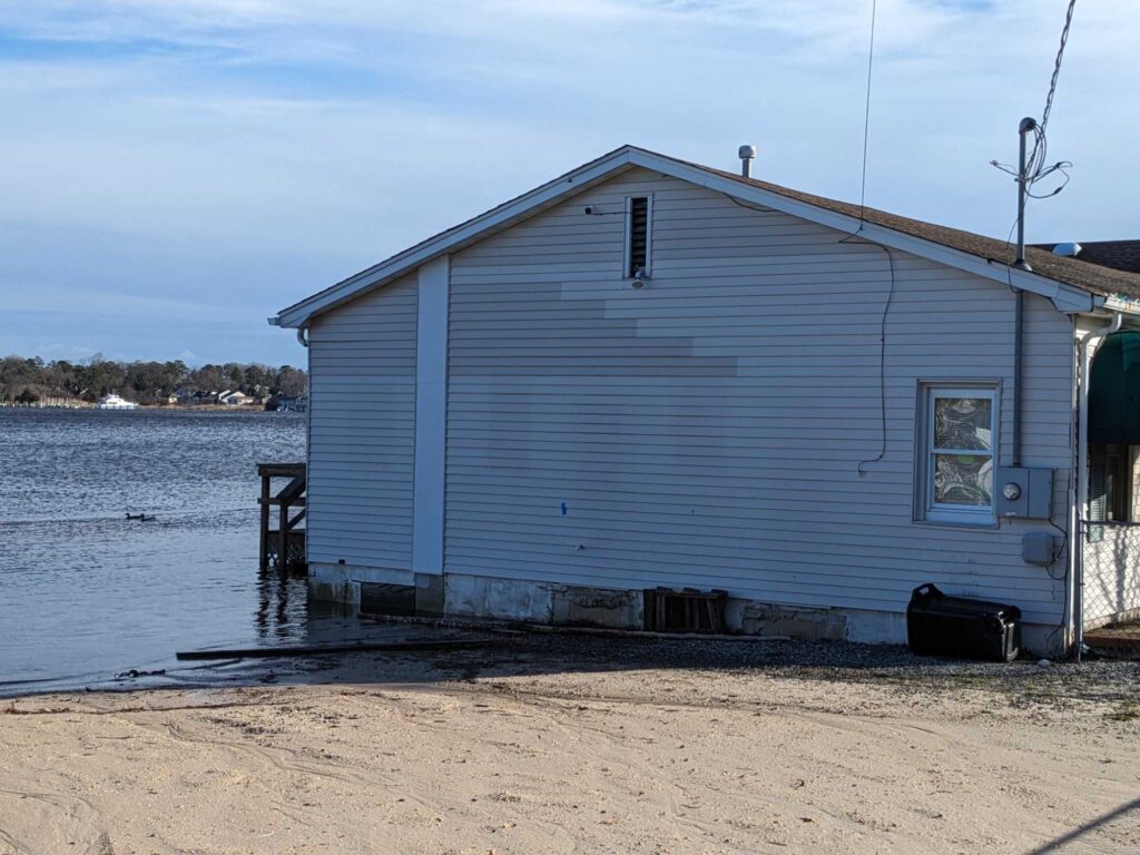 a white building on a beach (MyCoast AI)