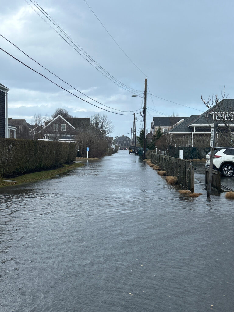 a flooded street with houses and cars (MyCoast AI)