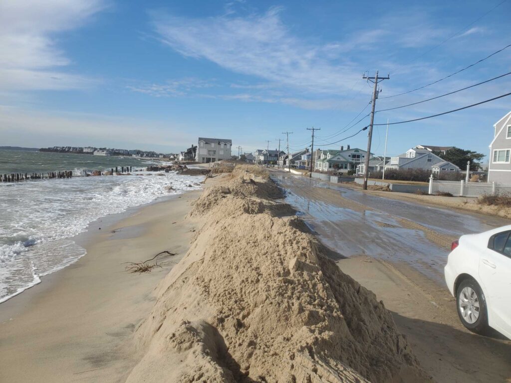 a sandy beach with a car parked on the side (MyCoast AI)