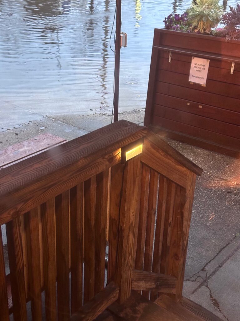 a wooden bench next to a body of water (MyCoast AI)