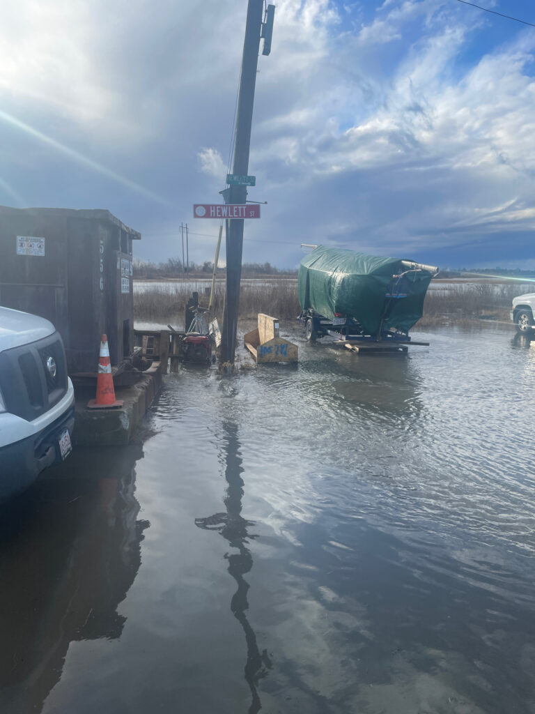 a flooded street with a sign (MyCoast AI)