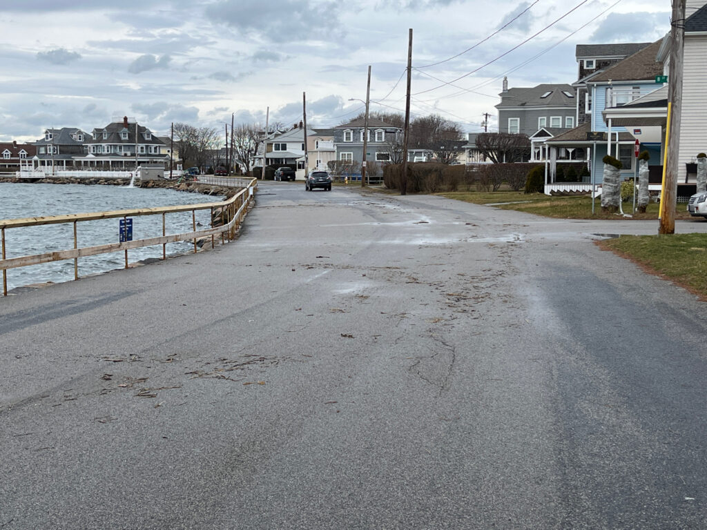 a road with a car on it by a body of water (MyCoast AI)