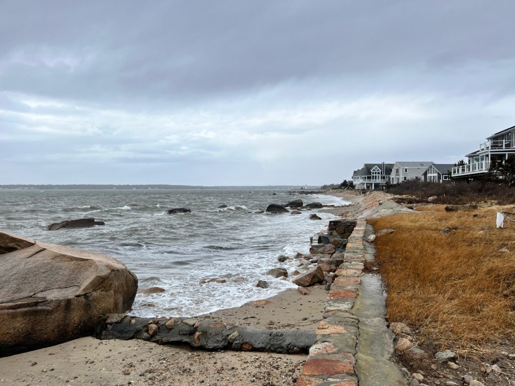a rocky beach with buildings and water (MyCoast AI)