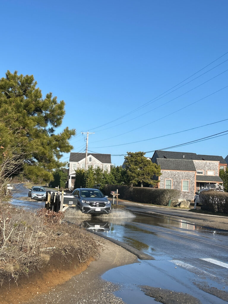a flooded street with cars and houses (MyCoast AI)