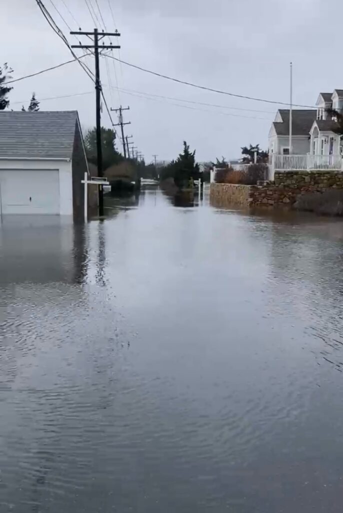 a flooded street with houses and power lines (MyCoast AI)
