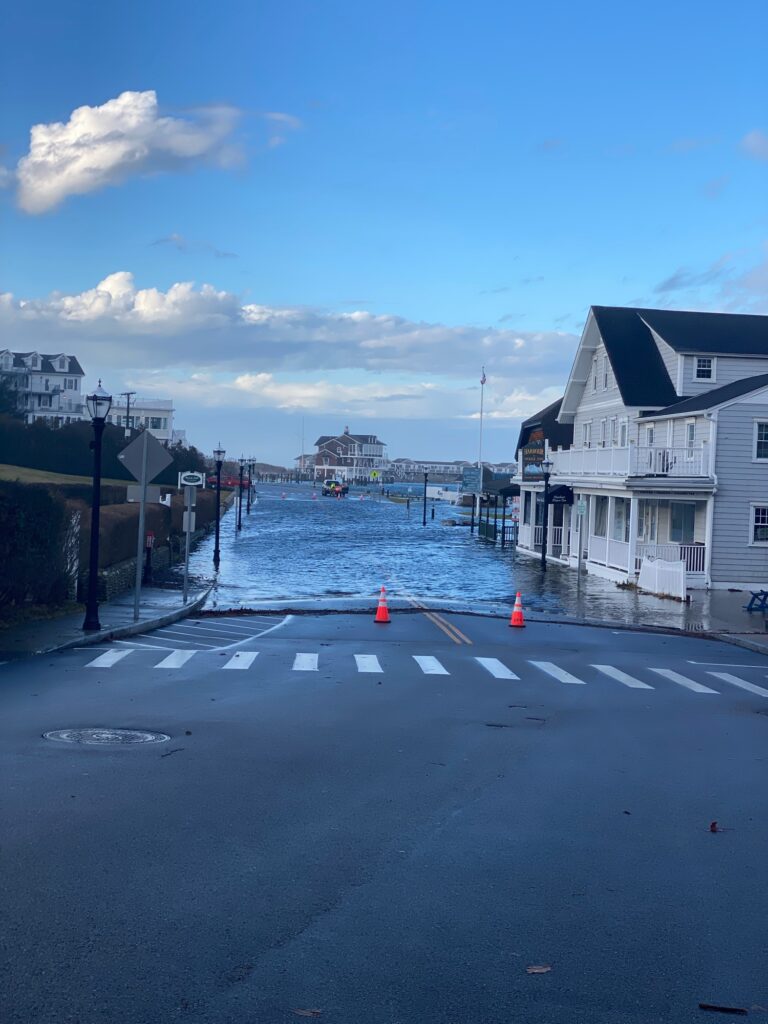 a road with a body of water and buildings on the side (MyCoast AI)