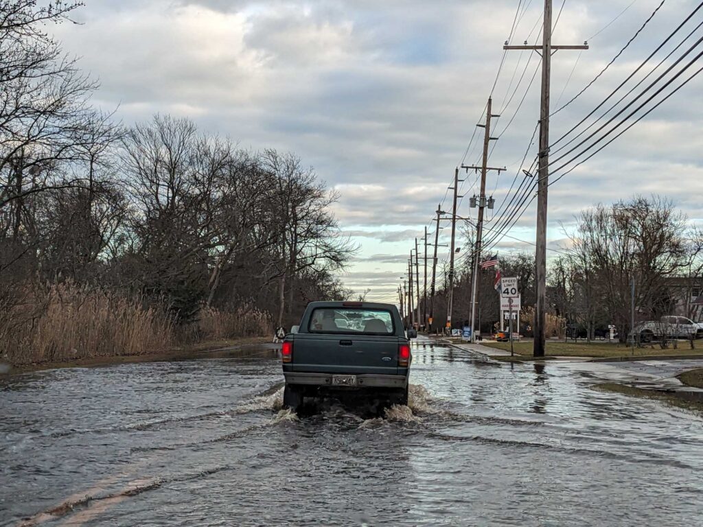 a truck driving through a flooded street (MyCoast AI)