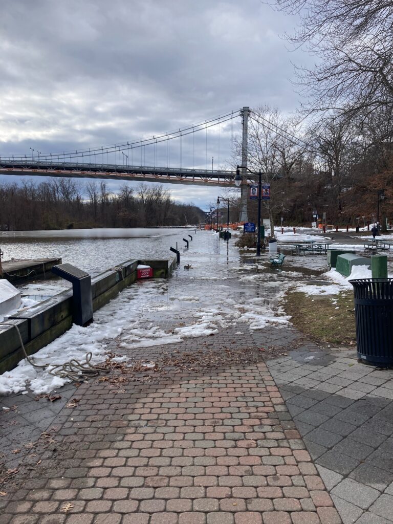 a brick walkway with a bridge over it and a body of water (MyCoast AI)