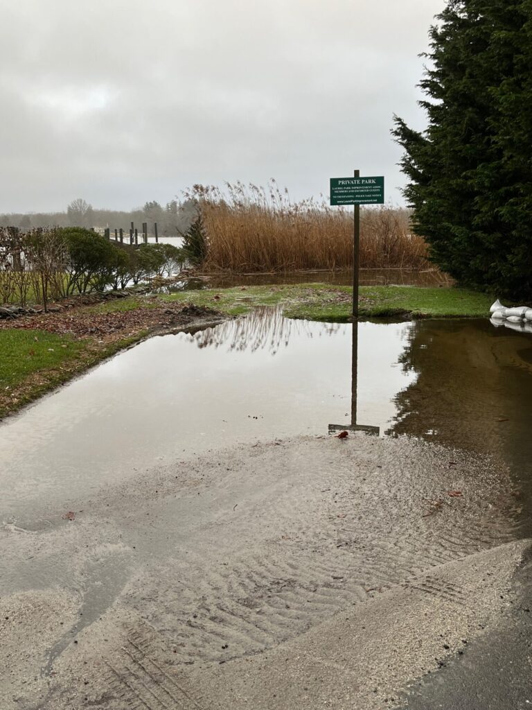 a flooded road with a sign (MyCoast AI)
