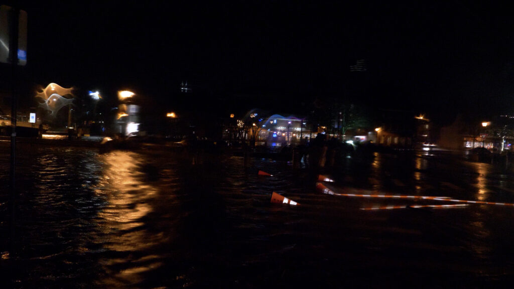 a body of water with buildings and lights in the background (MyCoast AI)