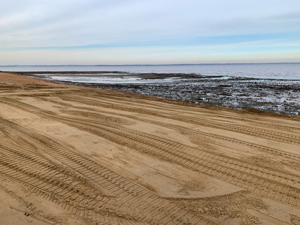 a sandy beach with waves crashing (MyCoast AI)