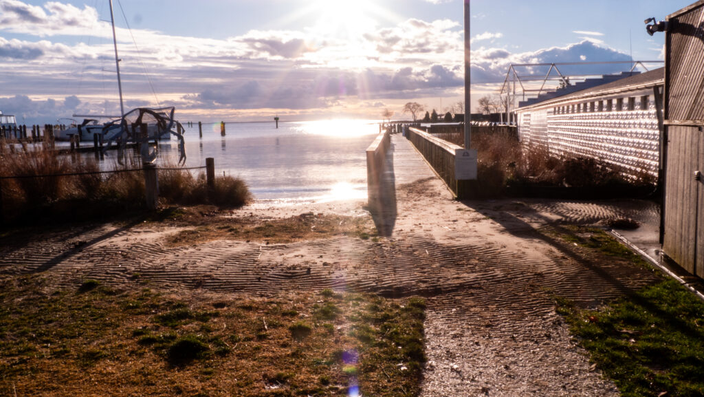 a dirt road next to a body of water (MyCoast AI)