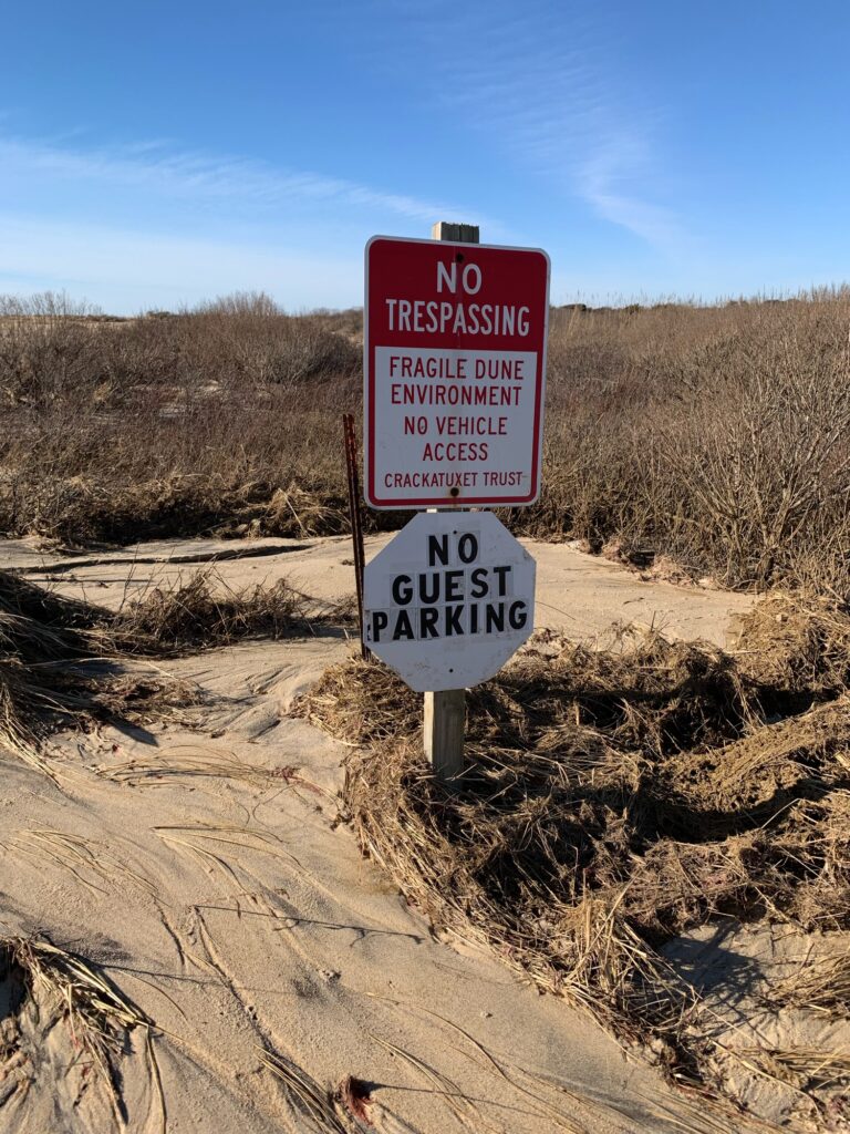 a sign on a dirt road (MyCoast AI)