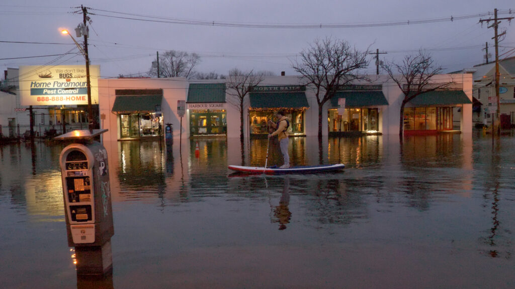 a person on a boat in a flooded area (MyCoast AI)