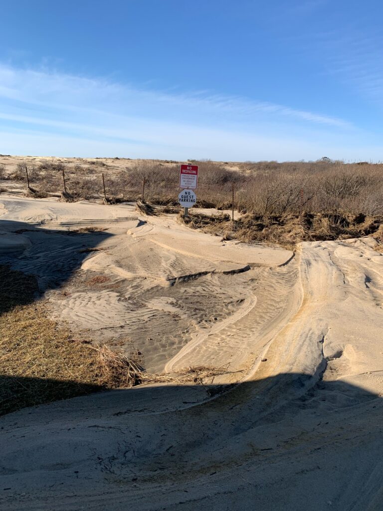 a sign on a dirt road (MyCoast AI)