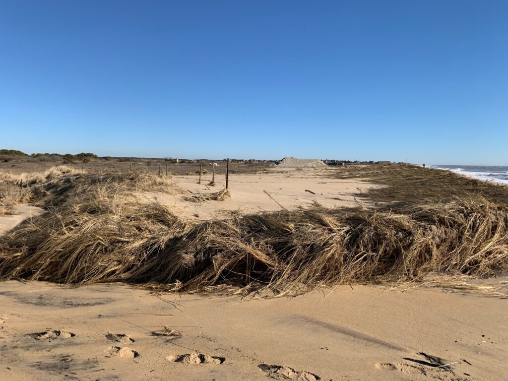 a sandy beach with a fence (MyCoast AI)