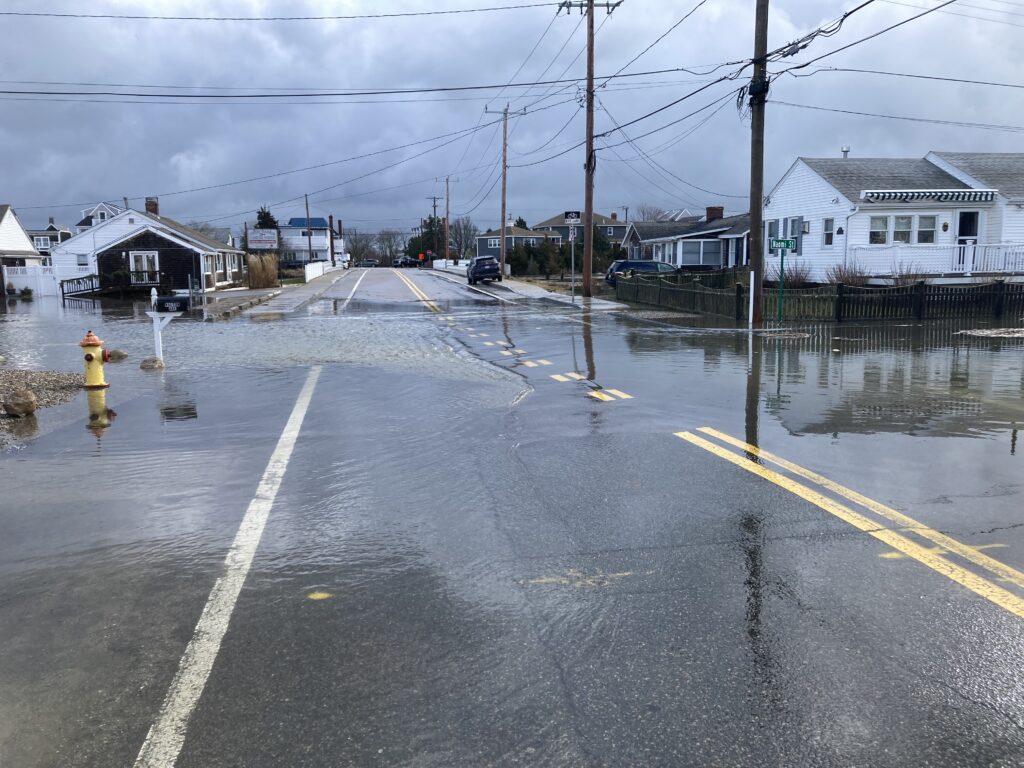 a wet street with houses along it (MyCoast AI)