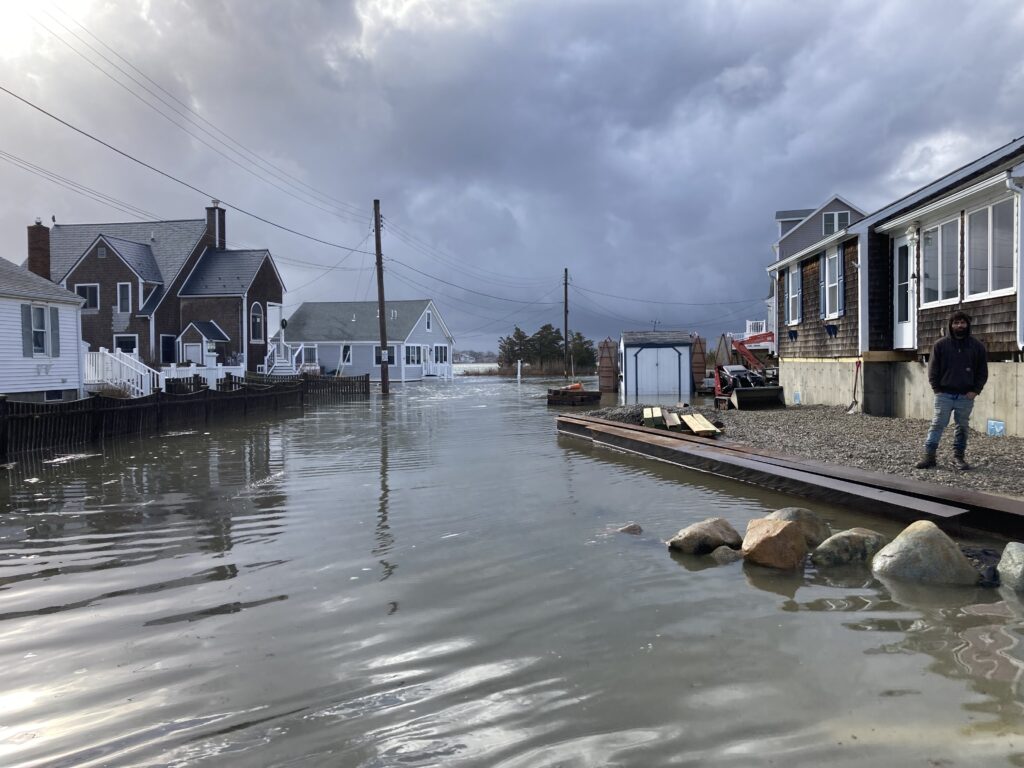 a person standing on a dock in a flooded area (MyCoast AI)