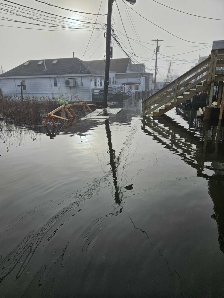 a flooded street with a house (MyCoast AI)