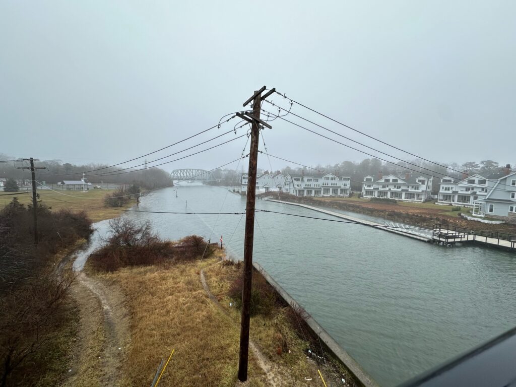 a river with a bridge and buildings along it (MyCoast AI)