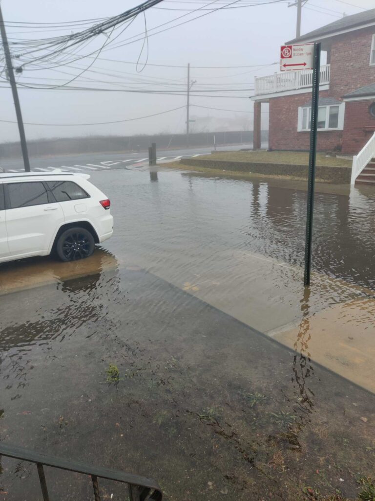 a flooded street with a car parked on the side (MyCoast AI)