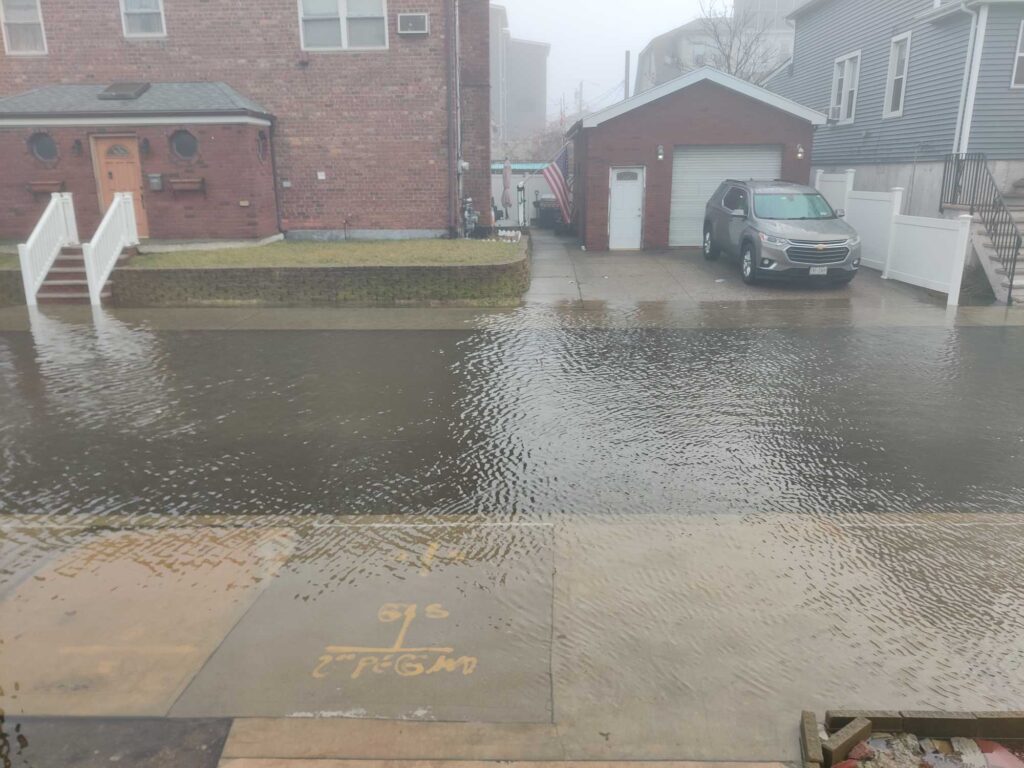a flooded street with a car parked on the side (MyCoast AI)