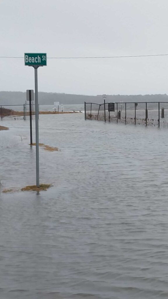 a flooded street with a sign (MyCoast AI)
