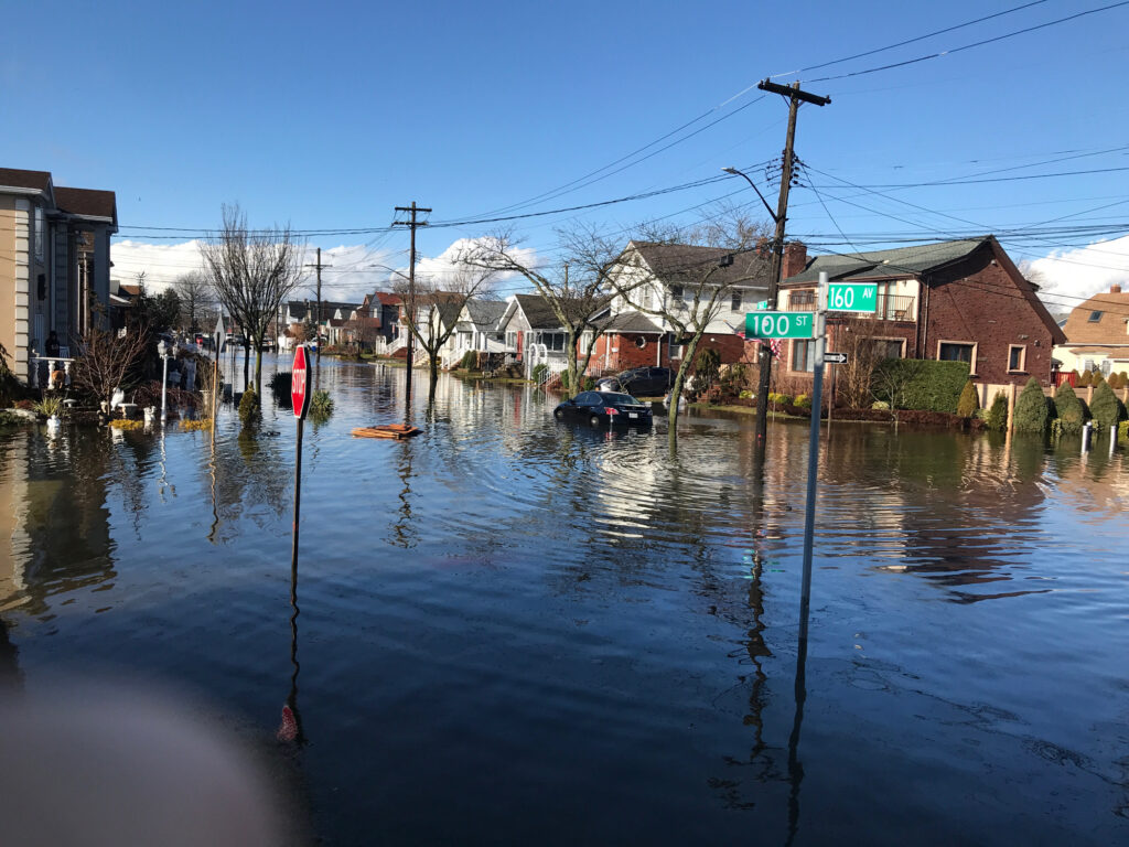 a flooded street with houses and cars (MyCoast AI)