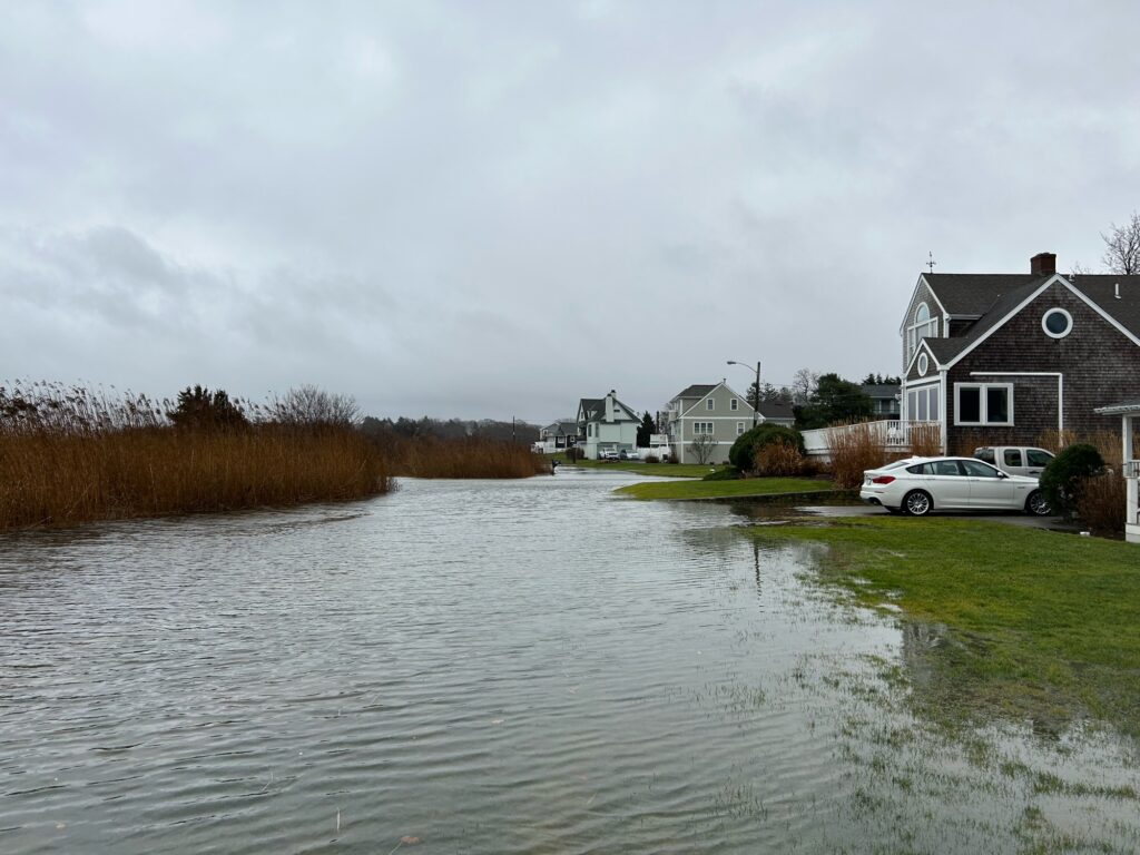 a flooded street with cars parked on the side (MyCoast AI)