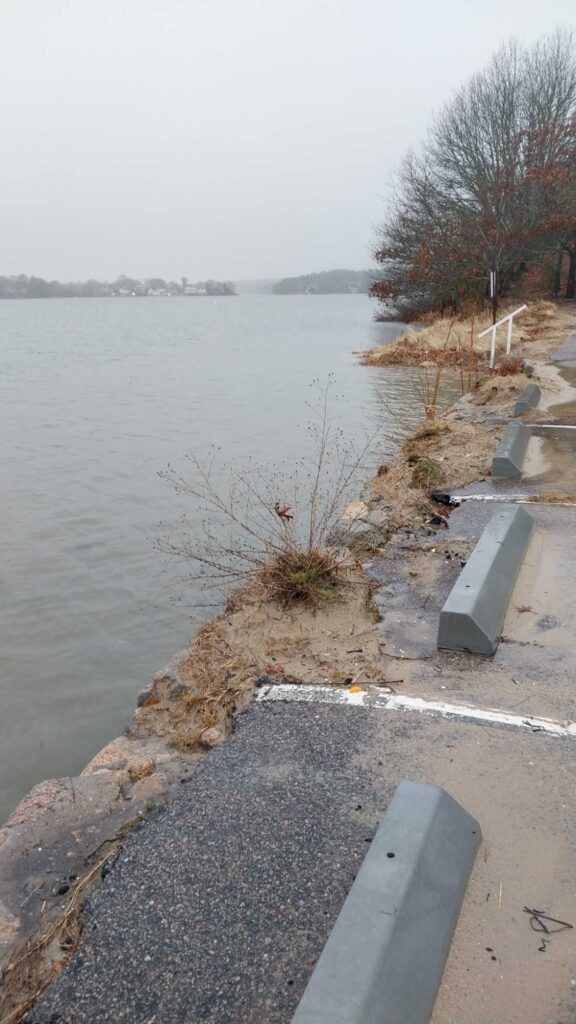 a body of water with a concrete path and a concrete wall (MyCoast AI)