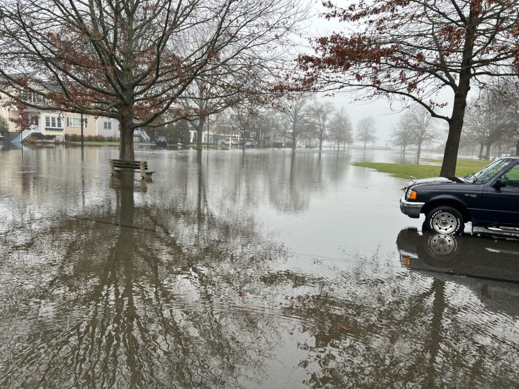 a flooded street with a car parked on the side (MyCoast AI)