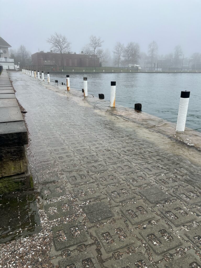 a stone walkway next to a body of water (MyCoast AI)