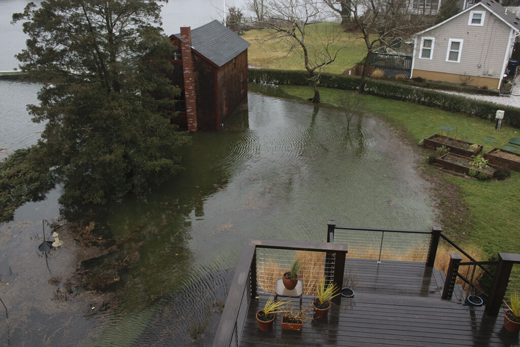 a flooded area with a house and a tree (MyCoast AI)