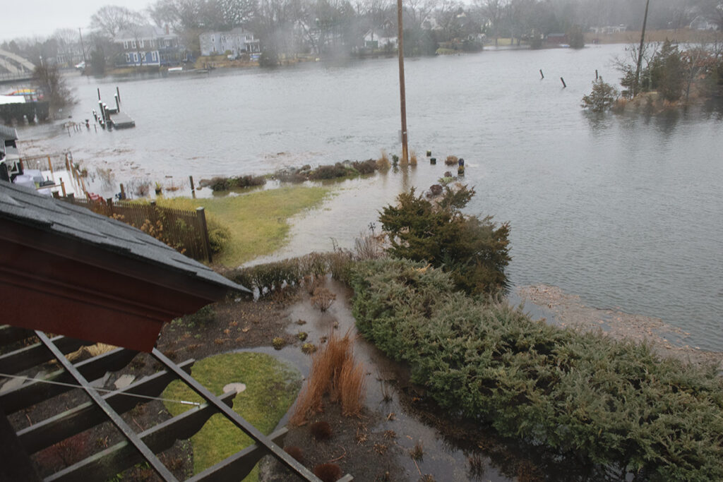 a flooded area with a dock and a group of ducks (MyCoast AI)