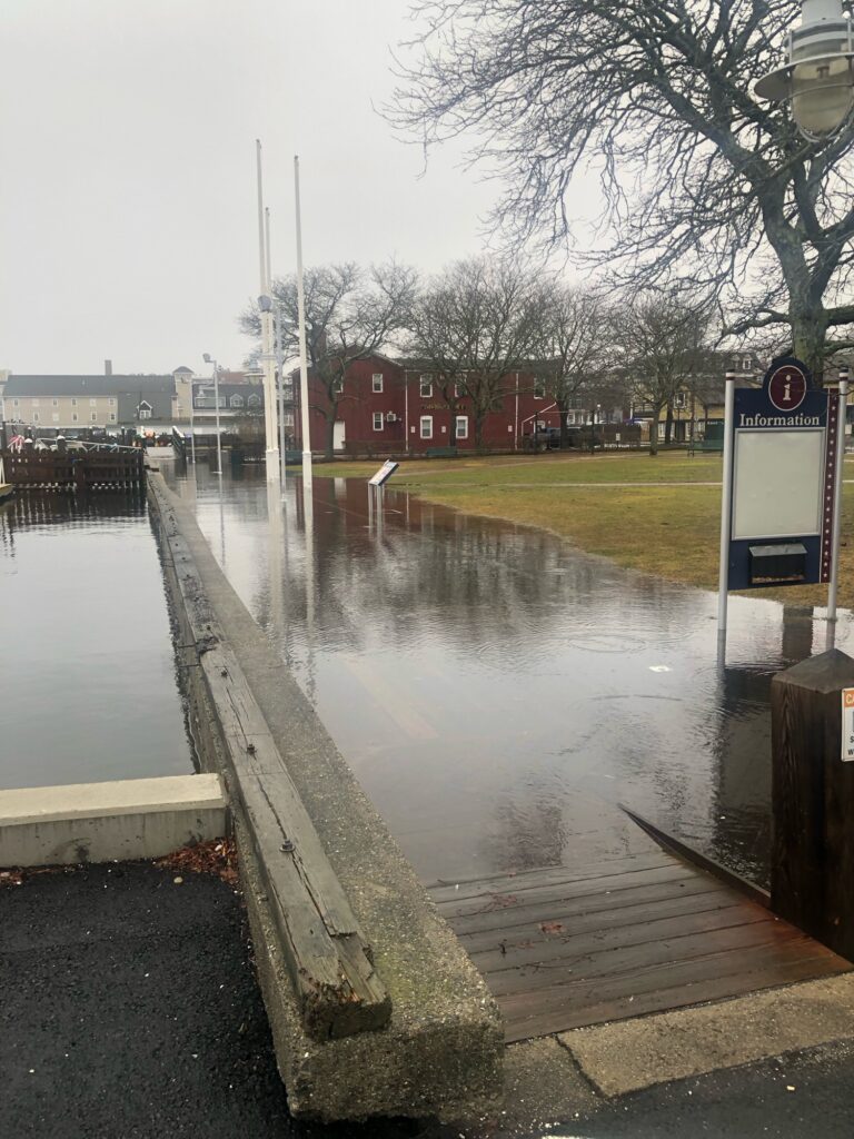 a flooded street with a sign (MyCoast AI)