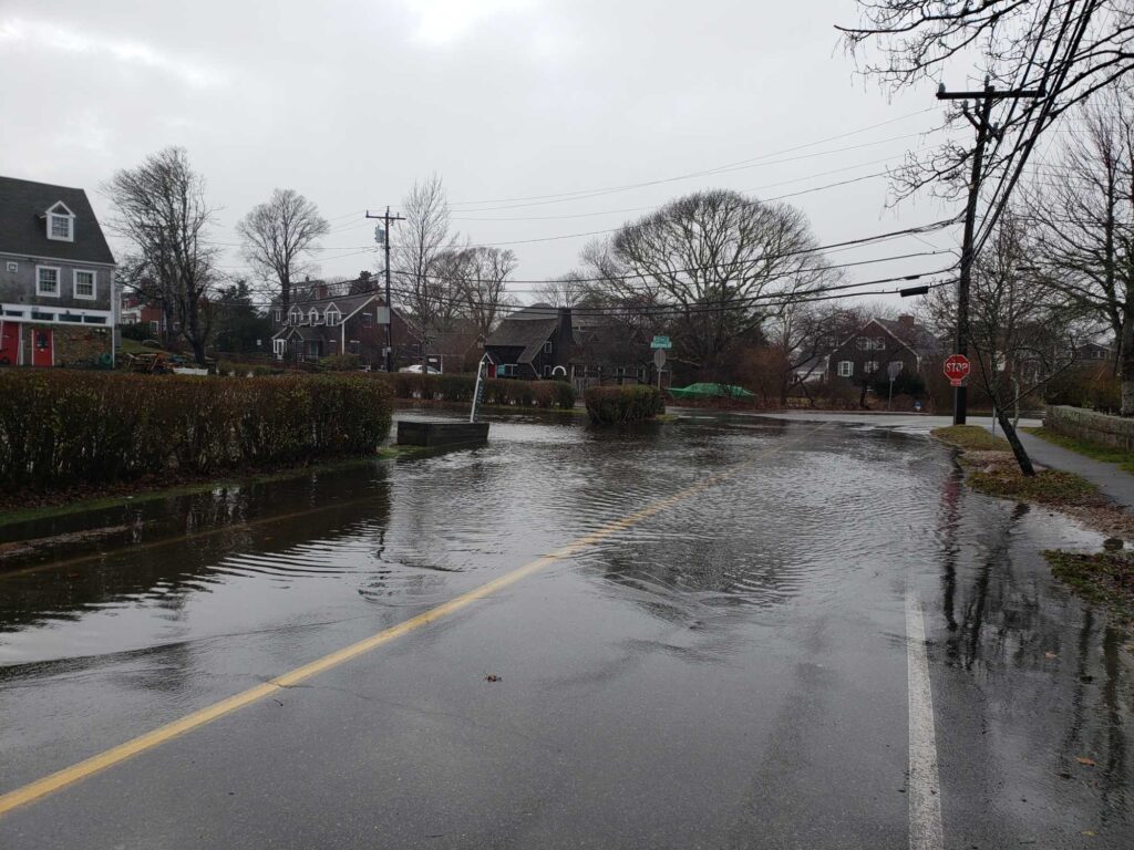 a flooded street with houses and trees (MyCoast AI)