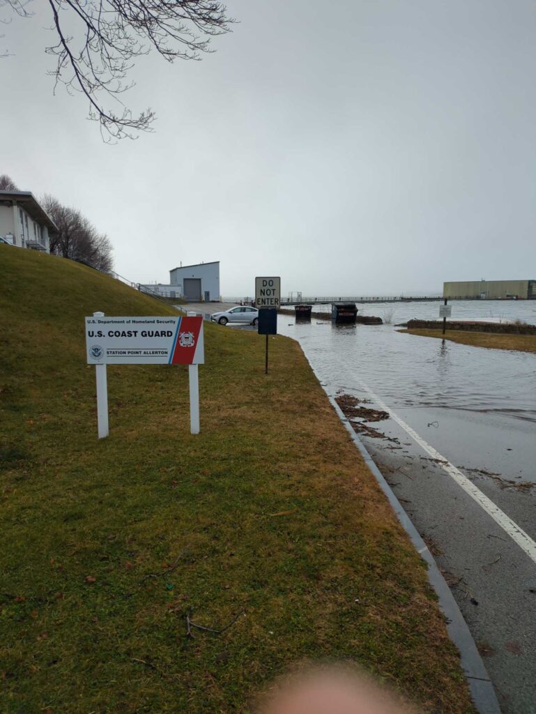 a road with signs on it by a body of water (MyCoast AI)