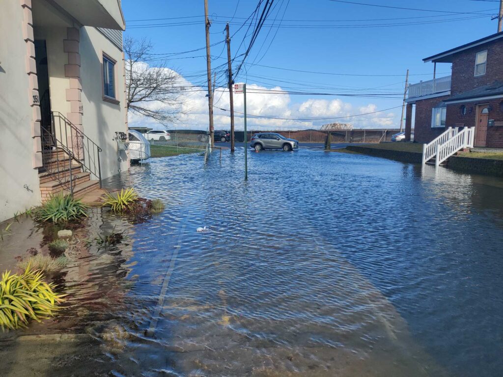 a flooded street with a car parked on the side (MyCoast AI)