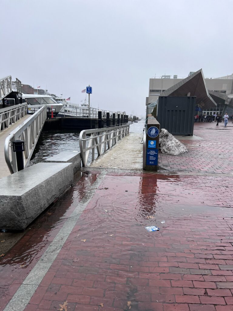 a brick walkway with a blue sign and a building with a blue sign (MyCoast AI)