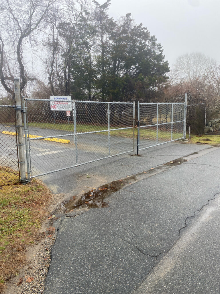 a road with a fence and trees on the side (MyCoast AI)