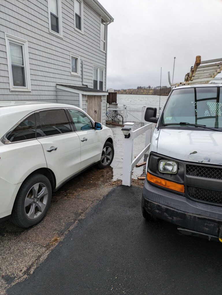 a couple of cars parked next to a house (MyCoast AI)
