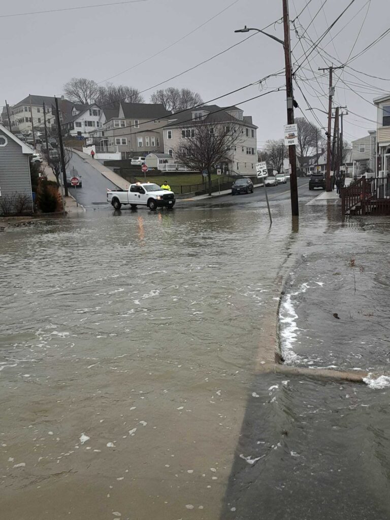 a flooded street with houses and cars (MyCoast AI)