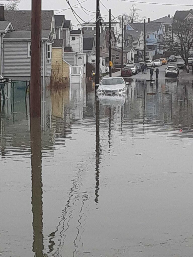 a flooded street with cars parked on the side (MyCoast AI)