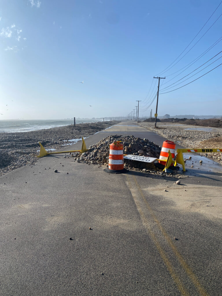 a road with a barrier and a road with a body of water in the background (MyCoast AI)