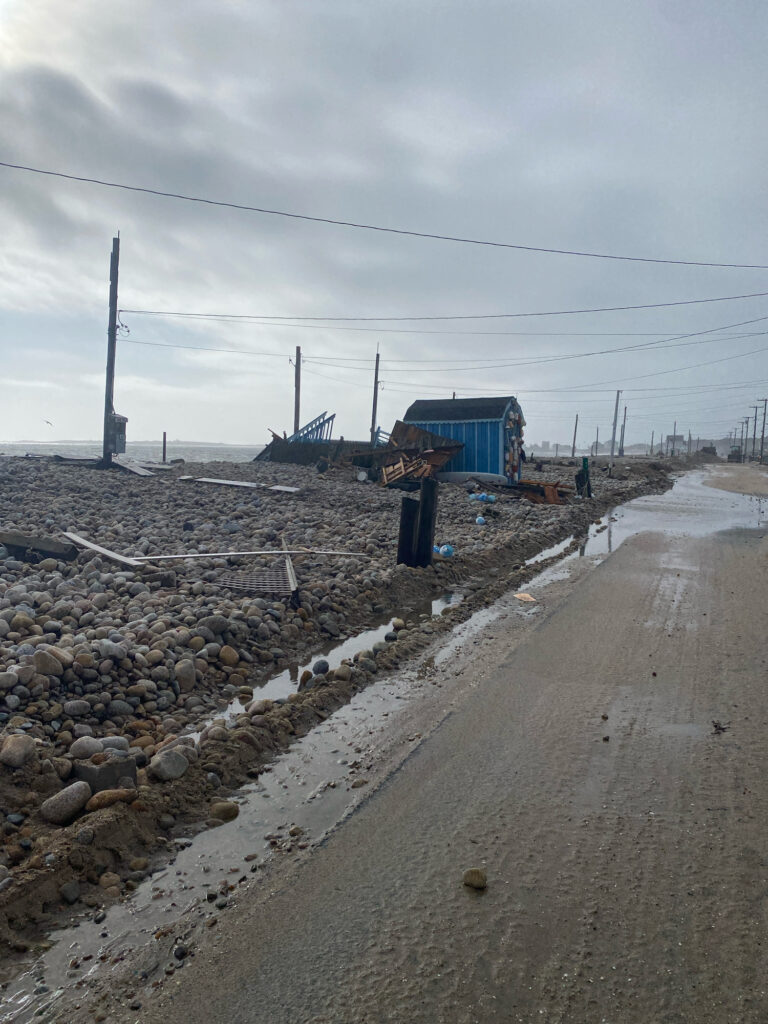 a road with rocks and a blue building on the side (MyCoast AI)