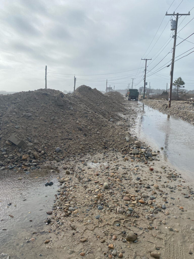 a road with a pile of dirt on the side and a truck on the side (MyCoast AI)