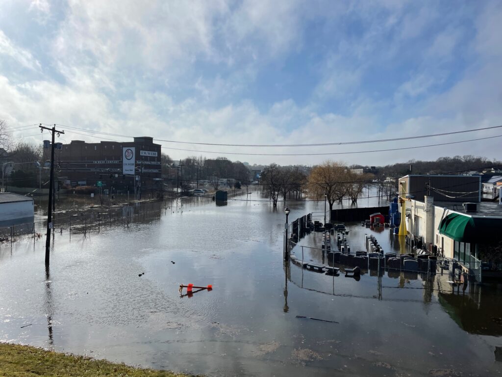 a flooded area with buildings and a boat in it (MyCoast AI)
