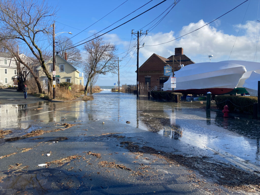 a flooded street with houses and power lines (MyCoast AI)