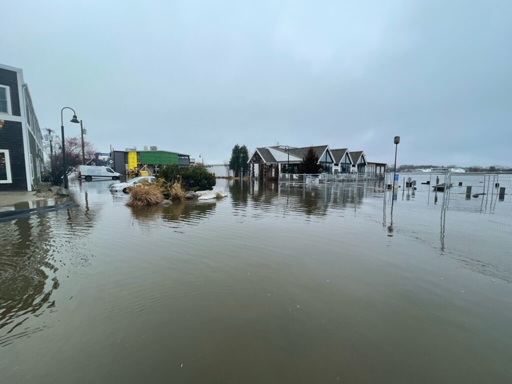 a flooded area with houses and a boat in it (MyCoast AI)