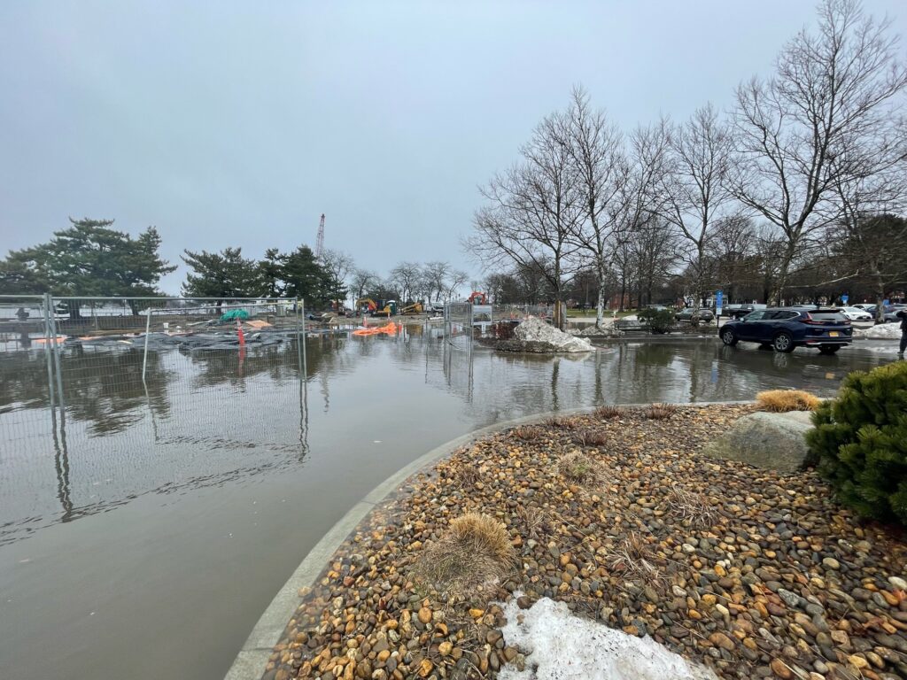 a body of water with a boat in it and a car parked on the side (MyCoast AI)
